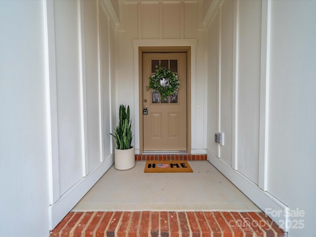 doorway to property featuring board and batten siding