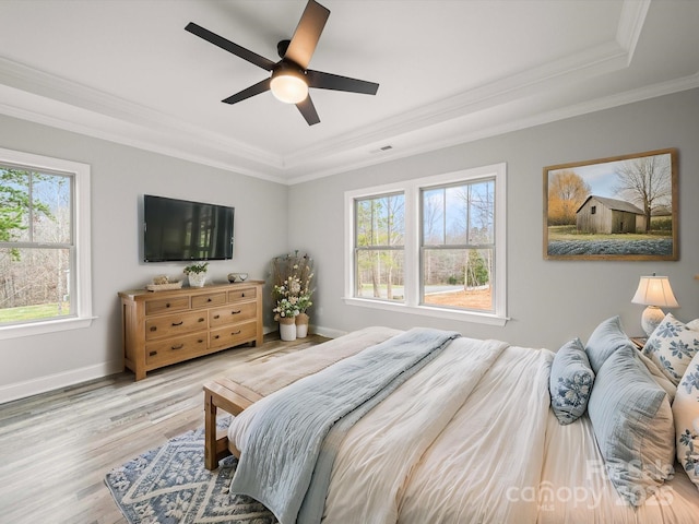 bedroom featuring visible vents, crown molding, ceiling fan, baseboards, and wood finished floors