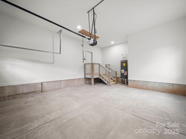 garage featuring recessed lighting, a garage door opener, and water heater