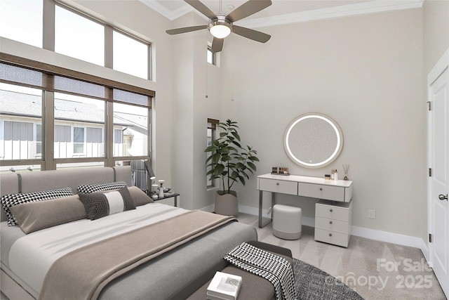 bedroom featuring baseboards, ornamental molding, light carpet, a towering ceiling, and a ceiling fan