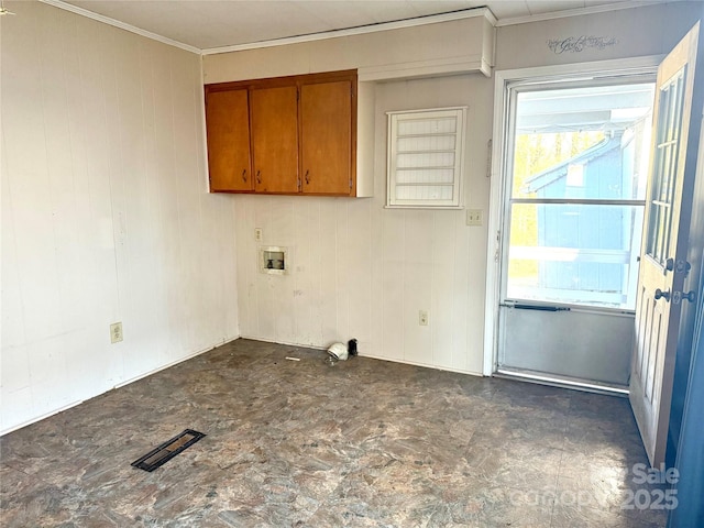 laundry area with washer hookup, visible vents, cabinet space, ornamental molding, and wood walls