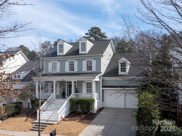 view of front of property with roof with shingles, a porch, concrete driveway, stairway, and a garage