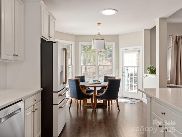 kitchen featuring white cabinetry, light countertops, fridge with ice dispenser, and stainless steel dishwasher