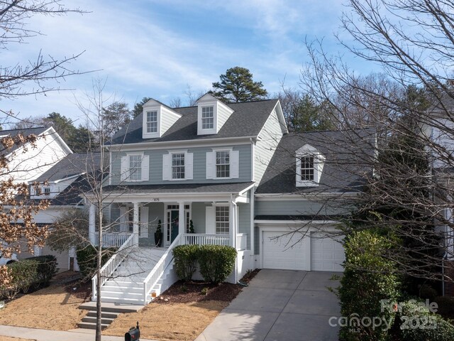 view of front of house with a porch, concrete driveway, stairs, roof with shingles, and a garage