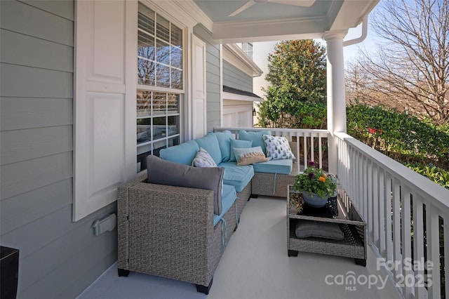 balcony featuring an outdoor living space, a porch, and ceiling fan