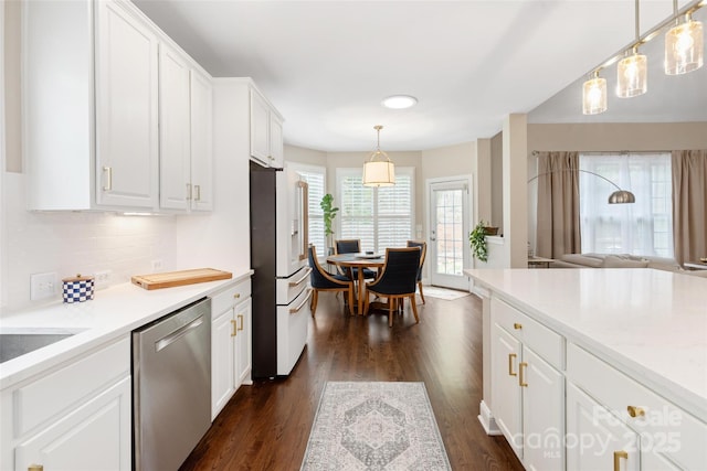 kitchen with dark wood-style floors, dishwasher, high end refrigerator, decorative backsplash, and white cabinetry