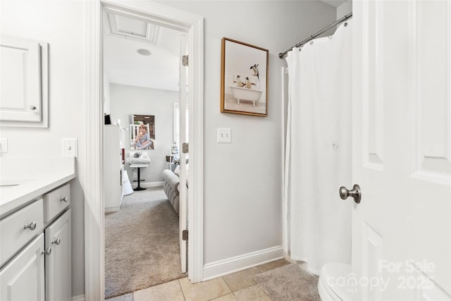 bathroom featuring baseboards, tile patterned flooring, and vanity