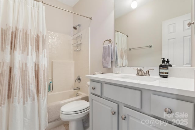 bathroom featuring shower / bath combination with curtain, vanity, and toilet