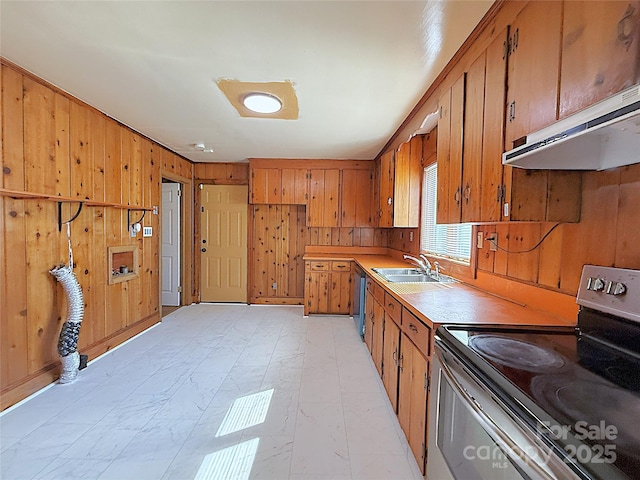 kitchen featuring stainless steel range with electric stovetop, brown cabinets, a sink, and under cabinet range hood