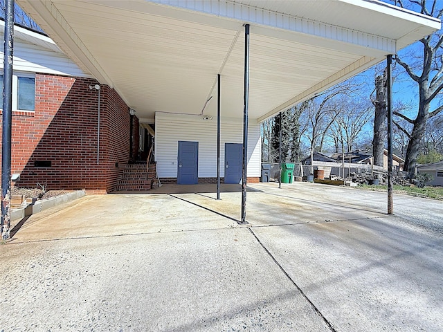 view of patio with a carport and concrete driveway