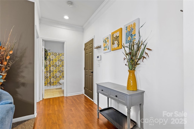 interior space with ornamental molding, recessed lighting, wood finished floors, and baseboards