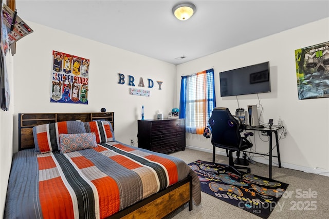 carpeted bedroom featuring baseboards