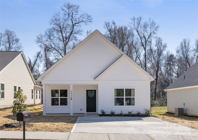 modern farmhouse style home featuring a porch and cooling unit