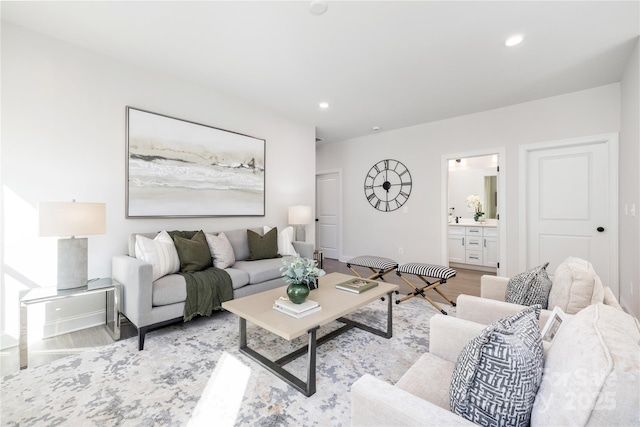 living area featuring recessed lighting, light wood-style floors, and baseboards