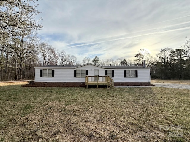 manufactured / mobile home featuring a deck, crawl space, and a front yard