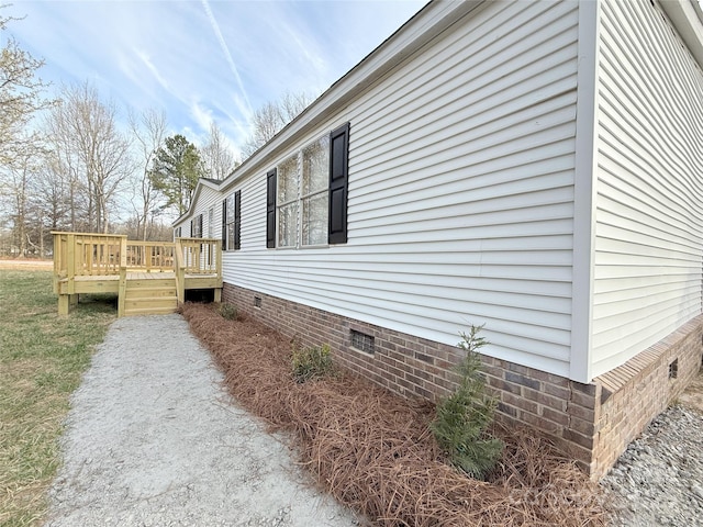 view of side of property featuring a deck and crawl space