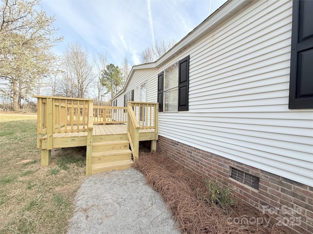 wooden terrace featuring a yard