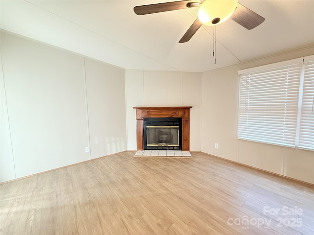 unfurnished living room featuring a fireplace with flush hearth, a ceiling fan, and wood finished floors