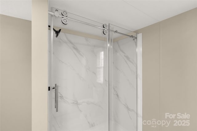full bath featuring a marble finish shower