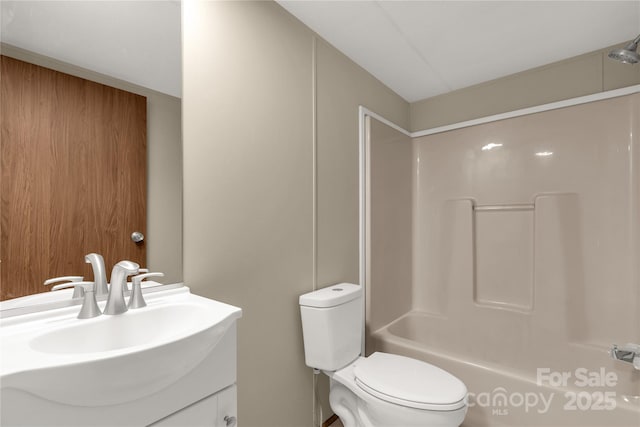 bathroom with toilet, vanity, and bathtub / shower combination