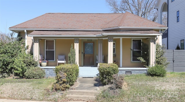 view of front of property featuring covered porch and roof with shingles