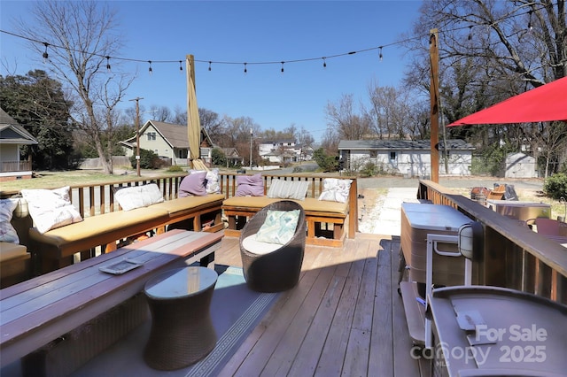 wooden terrace with a residential view, an outdoor living space, and an outbuilding