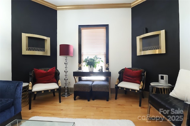 living area with ornamental molding and wood finished floors