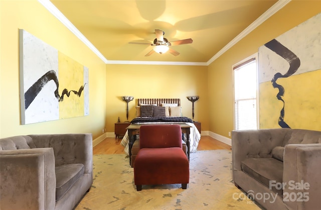 bedroom featuring ceiling fan, crown molding, baseboards, and wood finished floors