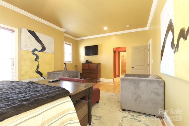 bedroom featuring baseboards, ornamental molding, and light wood-style floors