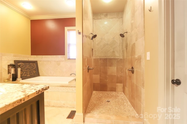 bathroom featuring a garden tub, ornamental molding, and a tile shower