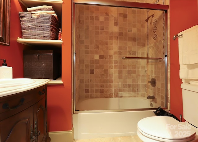 full bathroom featuring vanity, toilet, and bath / shower combo with glass door