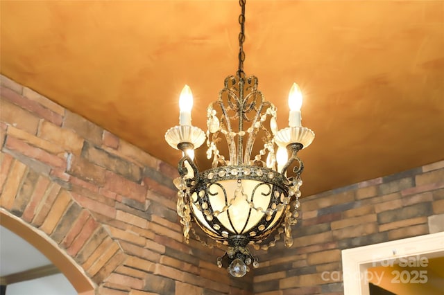 interior details featuring an inviting chandelier