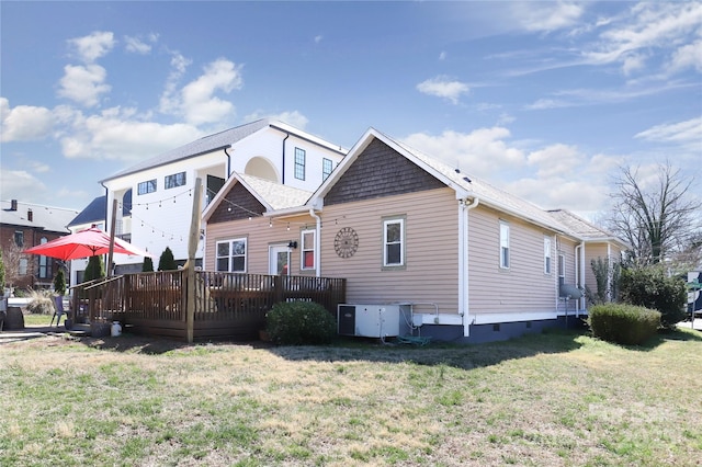 view of front of home with a front yard, crawl space, and a deck