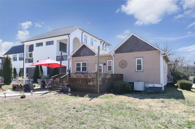 rear view of house featuring a lawn