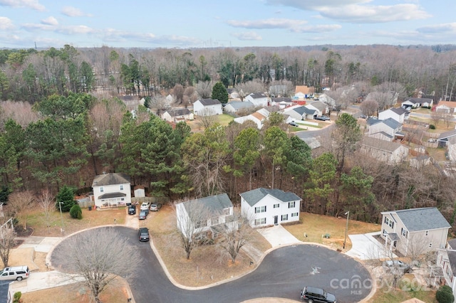 drone / aerial view with a residential view and a view of trees