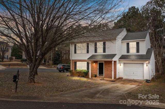 traditional-style house featuring brick siding, driveway, an attached garage, and roof with shingles