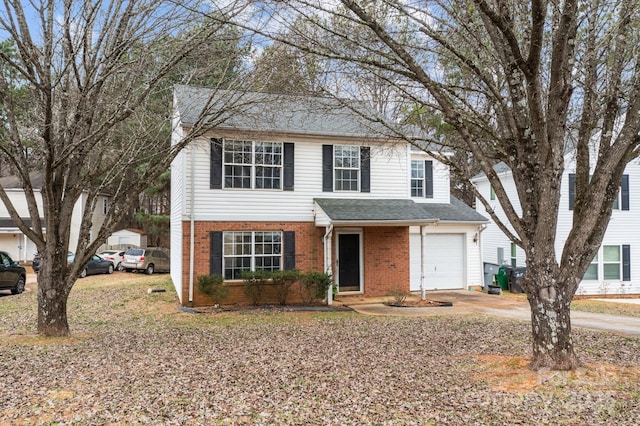 traditional-style home with brick siding, an attached garage, concrete driveway, and roof with shingles