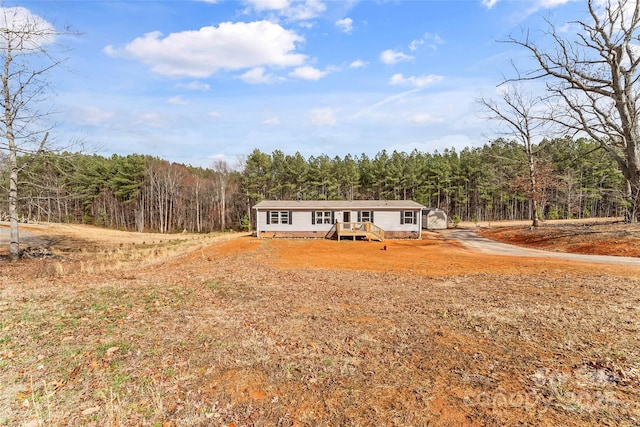 manufactured / mobile home with a wooded view