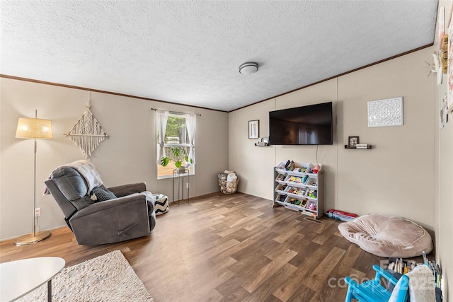 living room featuring ornamental molding, a textured ceiling, and wood finished floors