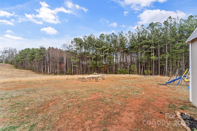 view of yard featuring a forest view