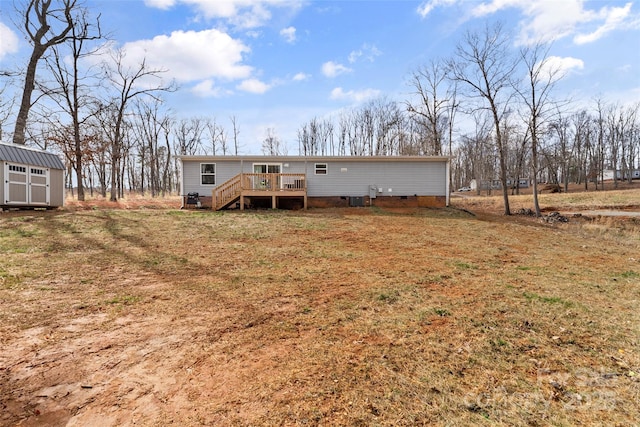 back of house with crawl space, a storage unit, a wooden deck, an outdoor structure, and central AC