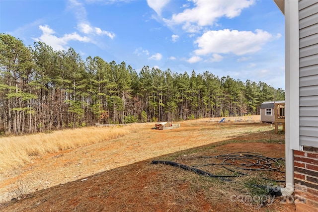 view of yard with a wooded view