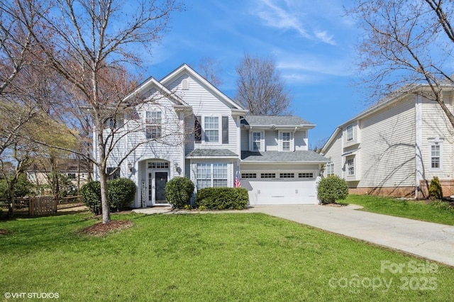 traditional-style home with a garage, driveway, fence, and a front lawn