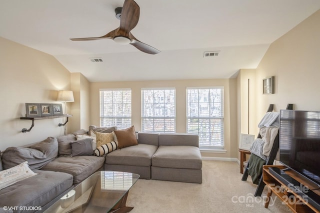 living room with a ceiling fan, light colored carpet, visible vents, and vaulted ceiling