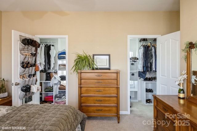 bedroom featuring carpet floors, a closet, connected bathroom, and a spacious closet