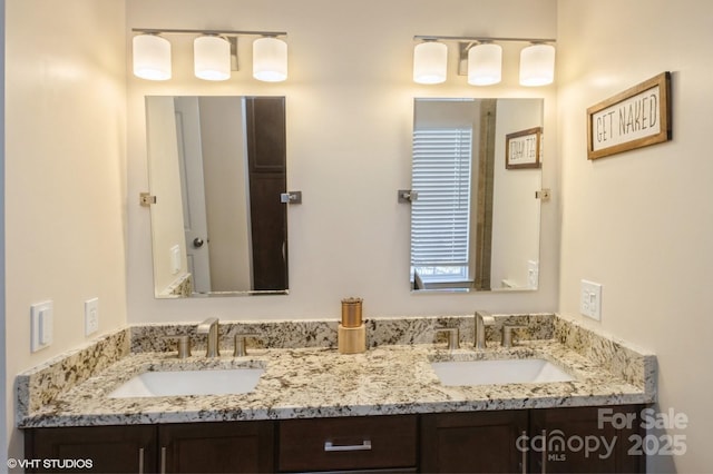 full bathroom with double vanity and a sink