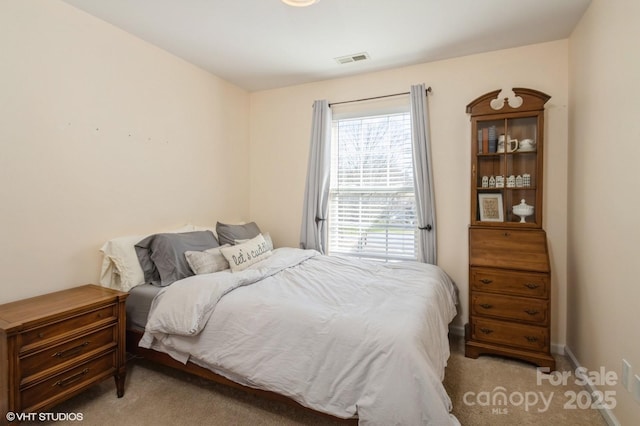 bedroom featuring carpet, visible vents, and baseboards