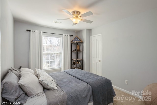 carpeted bedroom with a ceiling fan, visible vents, and baseboards