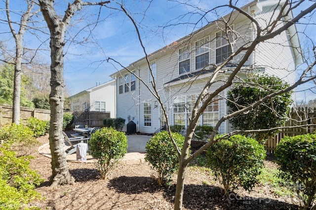 rear view of house featuring a patio area and fence