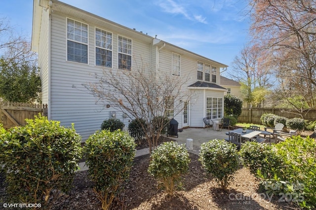 back of property with a patio area and fence